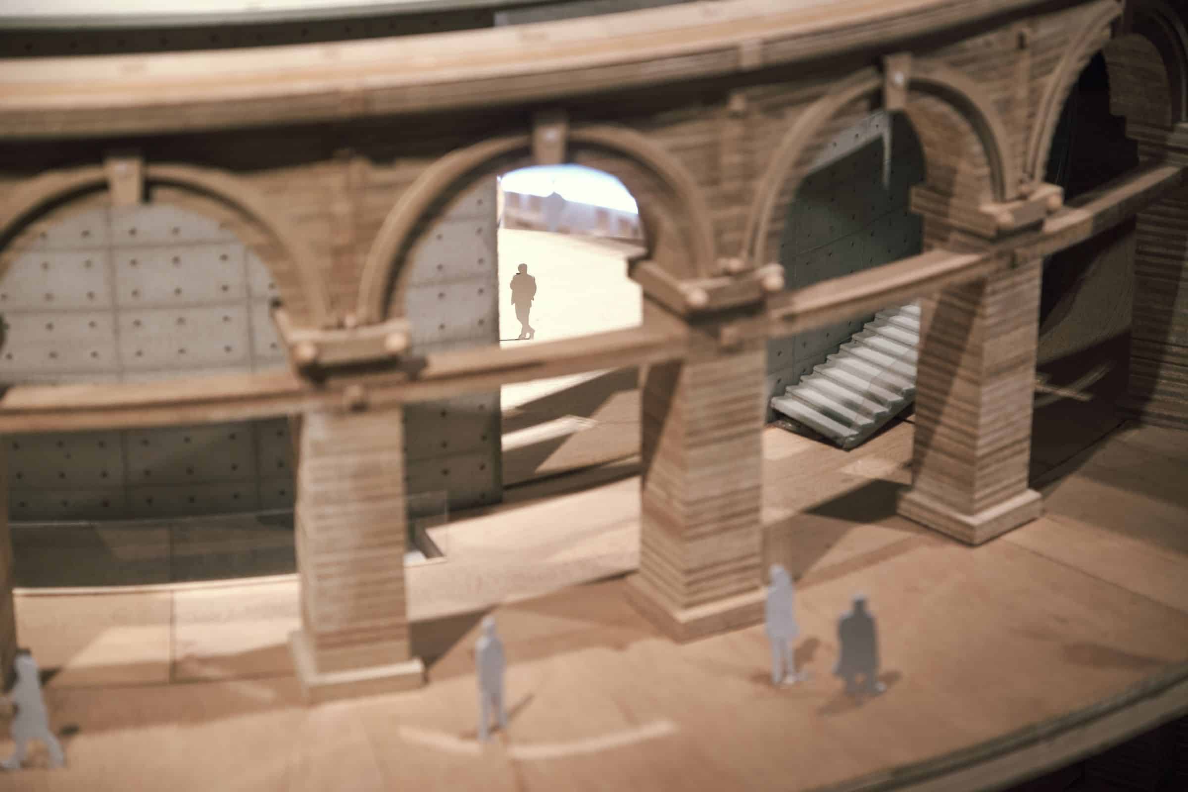 Detailed timber architectural model with arched colonnade in warm light