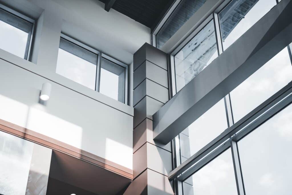 Angled concrete and glass building facade in daylight