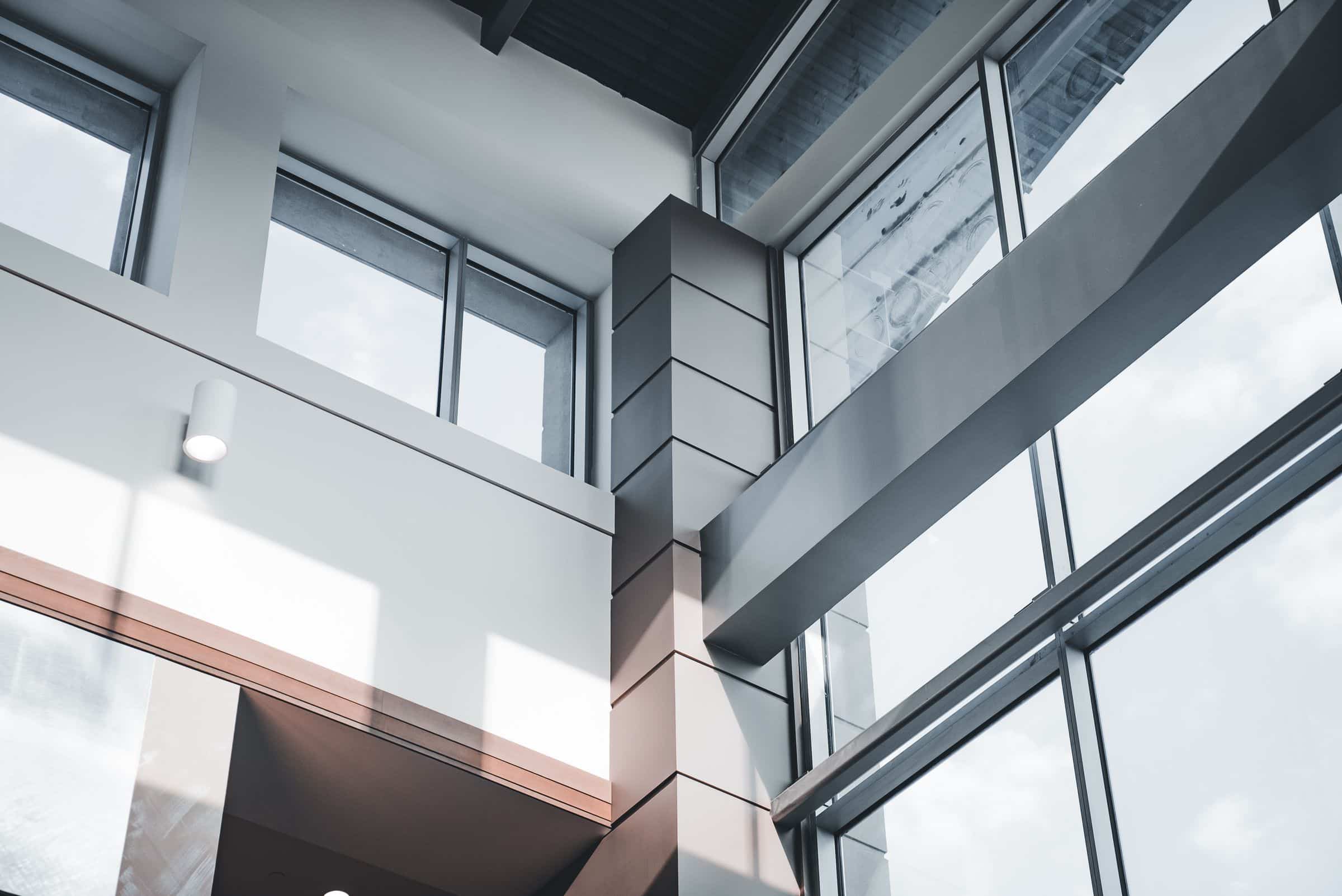 Angled concrete and glass building facade in daylight