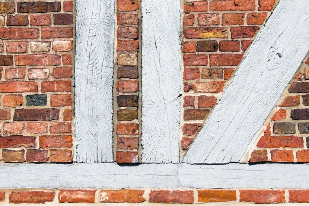 Close-up of white-painted brick and exposed timber framing