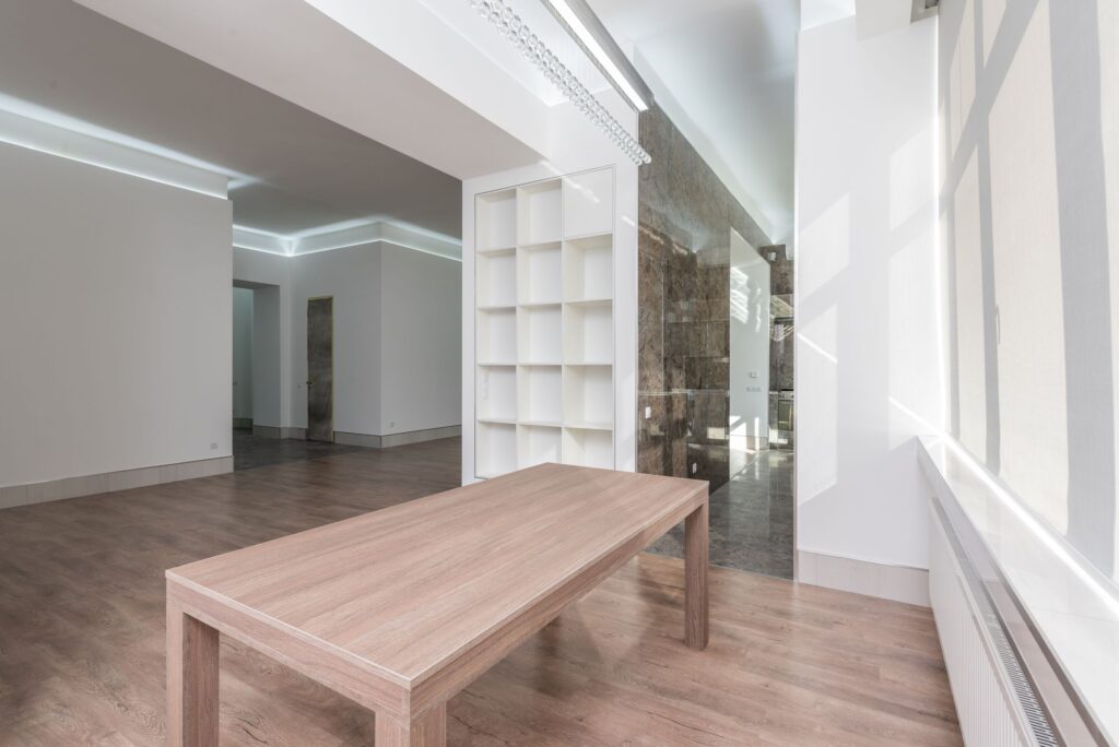 Bright minimalist interior with a long timber table and natural light