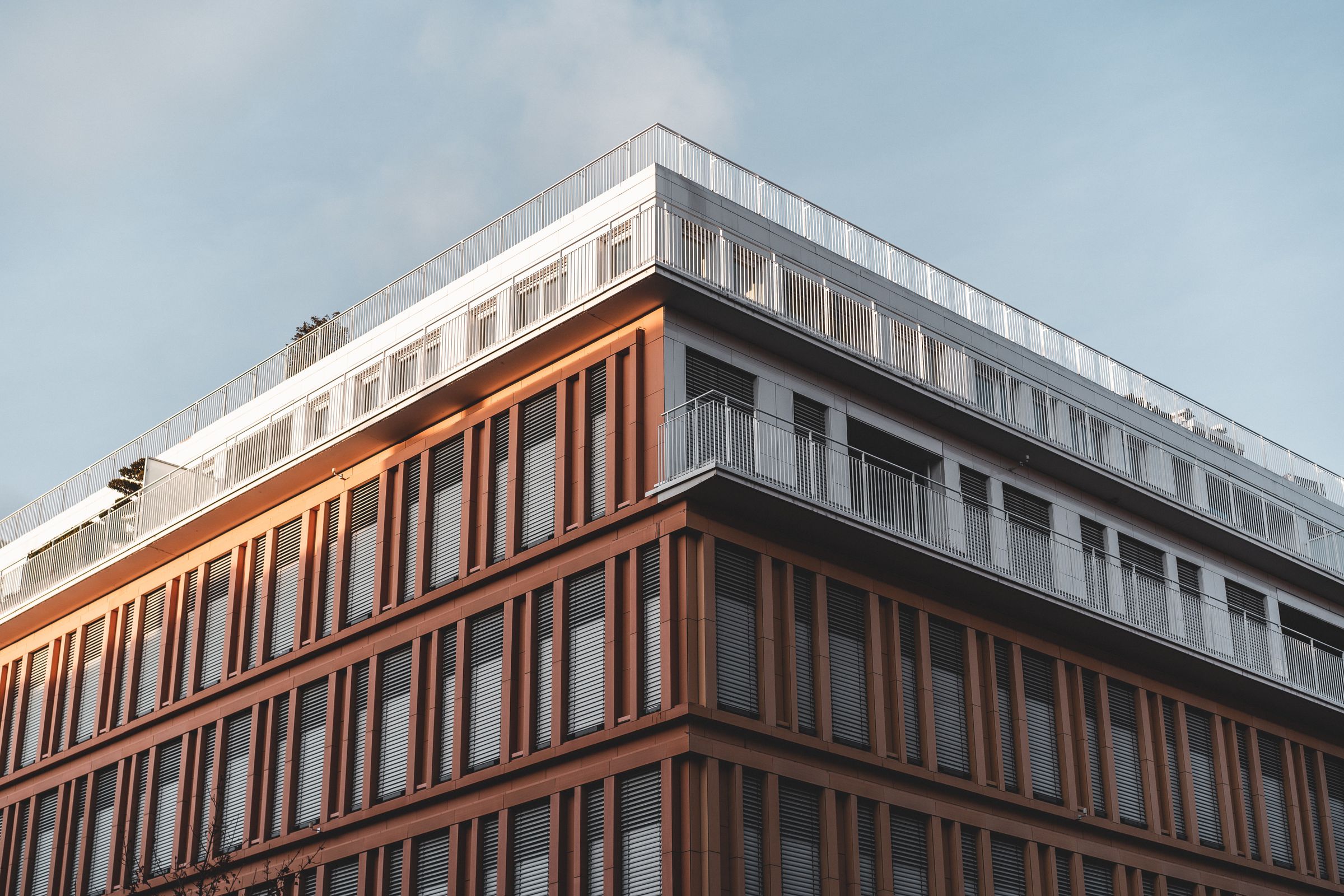 Commercial building facade with terracotta panels and stepped glazing