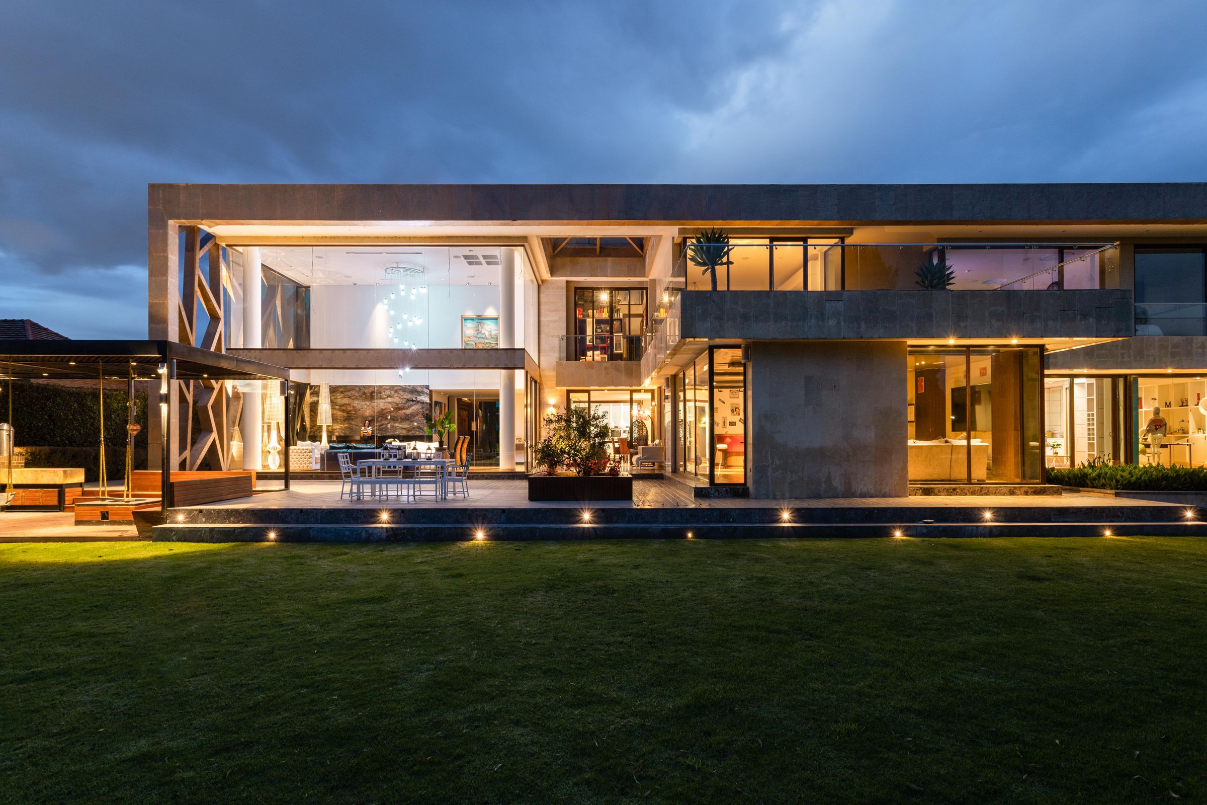 Contemporary residence with illuminated glazing at dusk