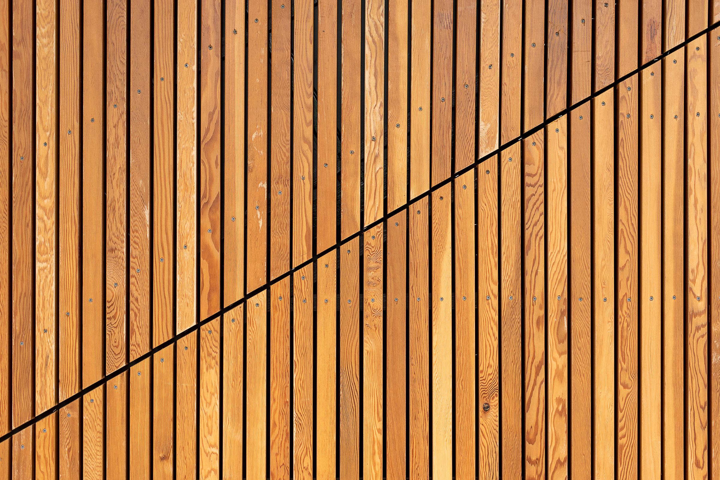 Diagonal timber slat cladding detail with steel cabling