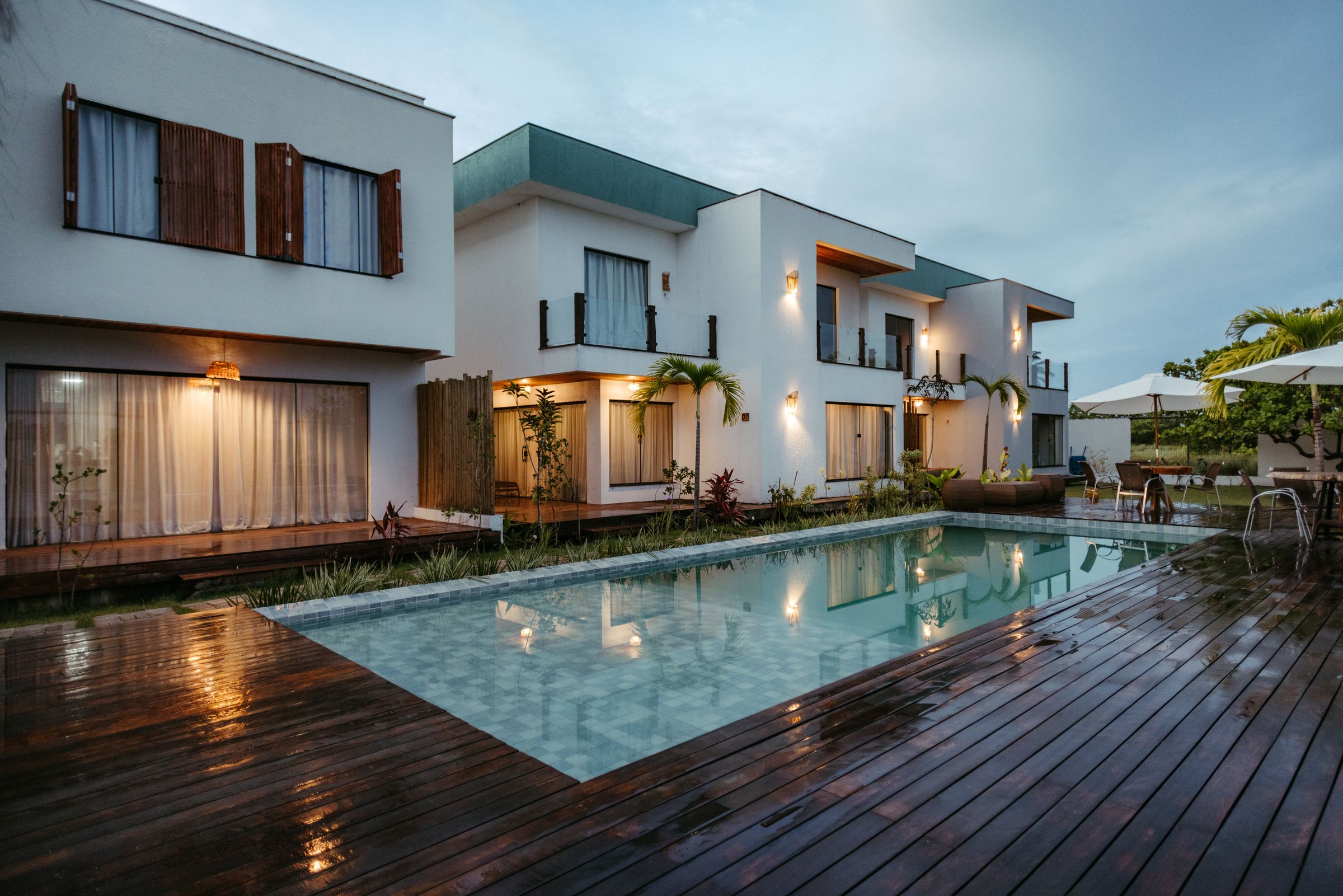 Modern villa with stone cladding and illuminated interiors at dusk