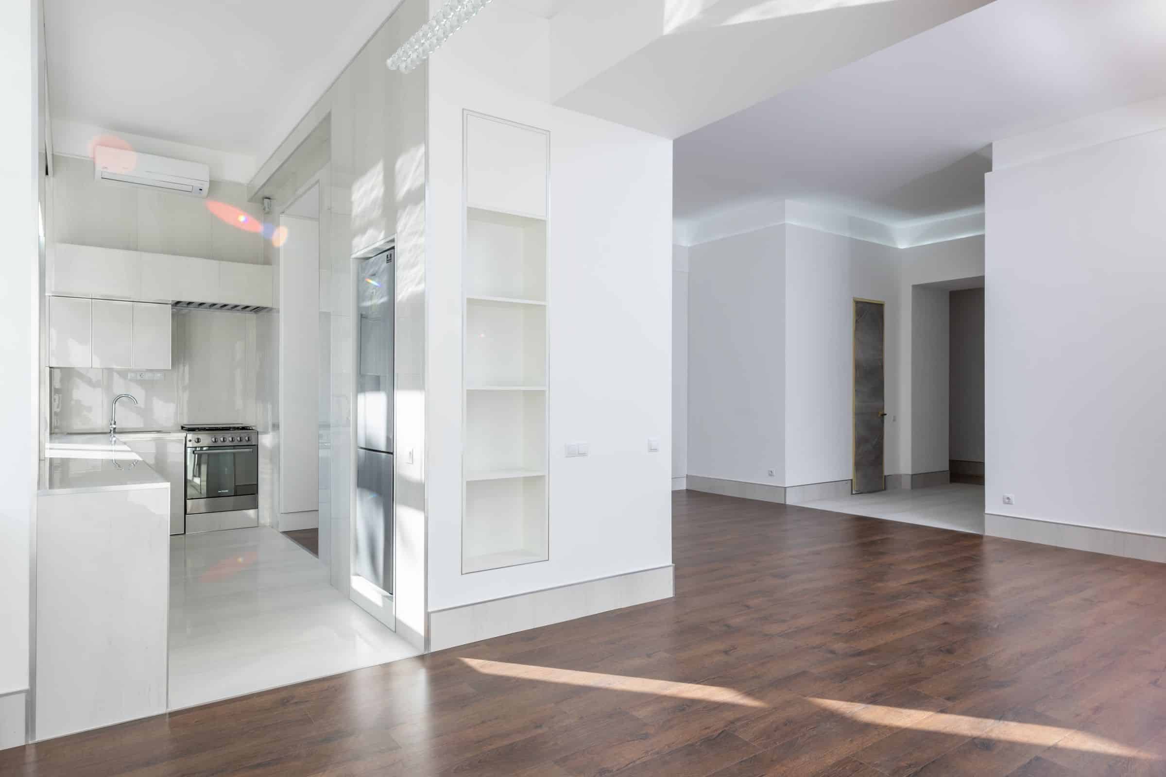 Bright renovated apartment interior with pale walls and timber flooring