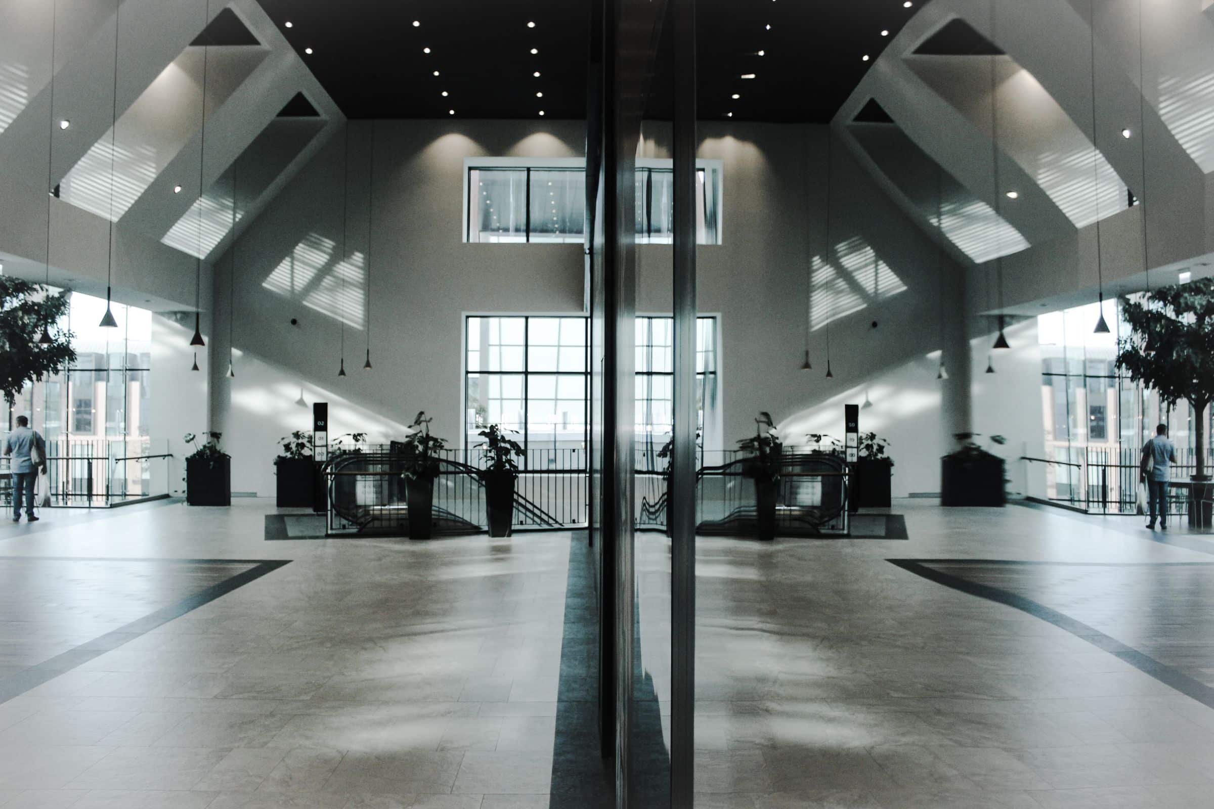 Grand modern lobby interior with columns and reflective polished floor