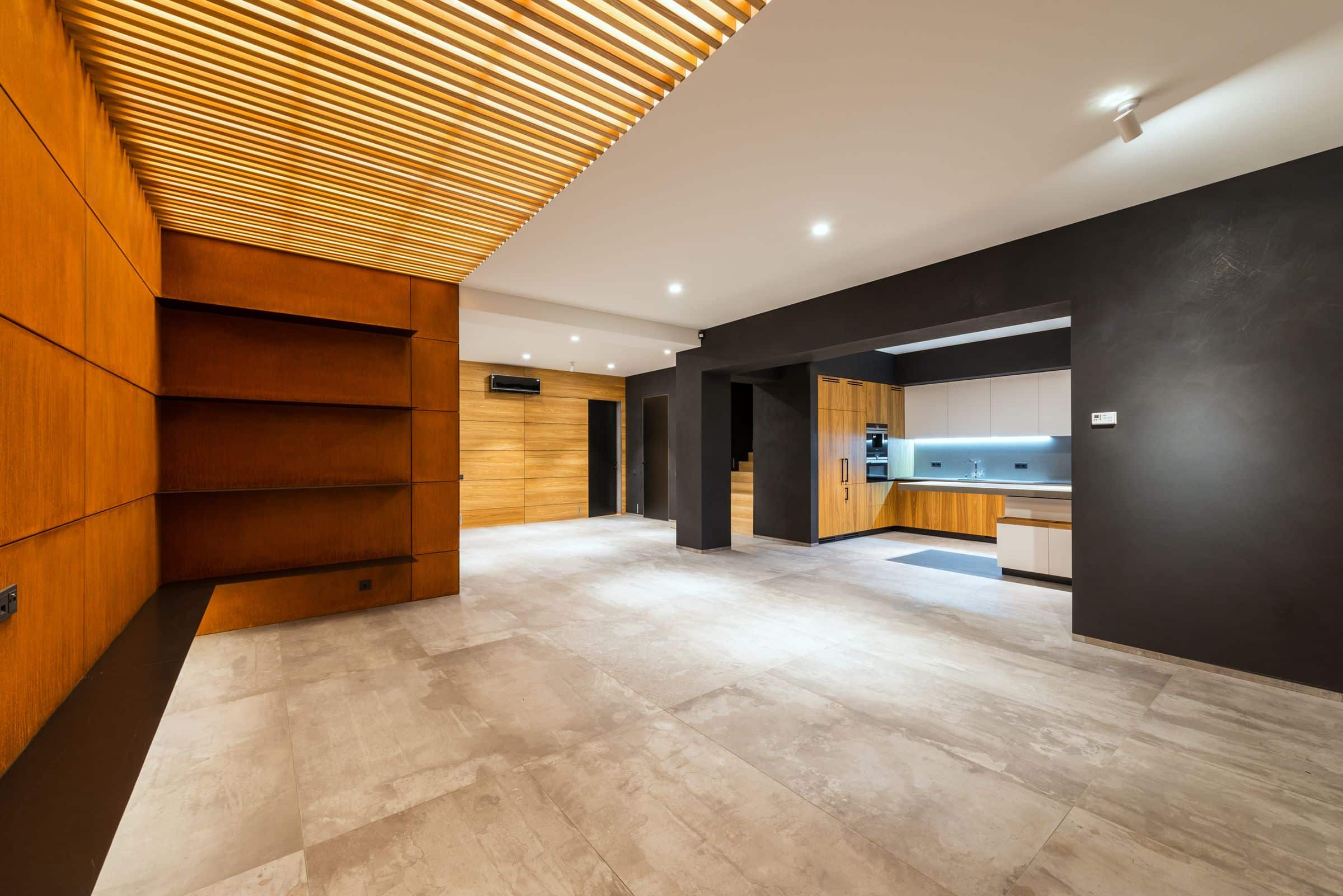 Renovated interior with walnut cabinetry and stone surfaces in warm light