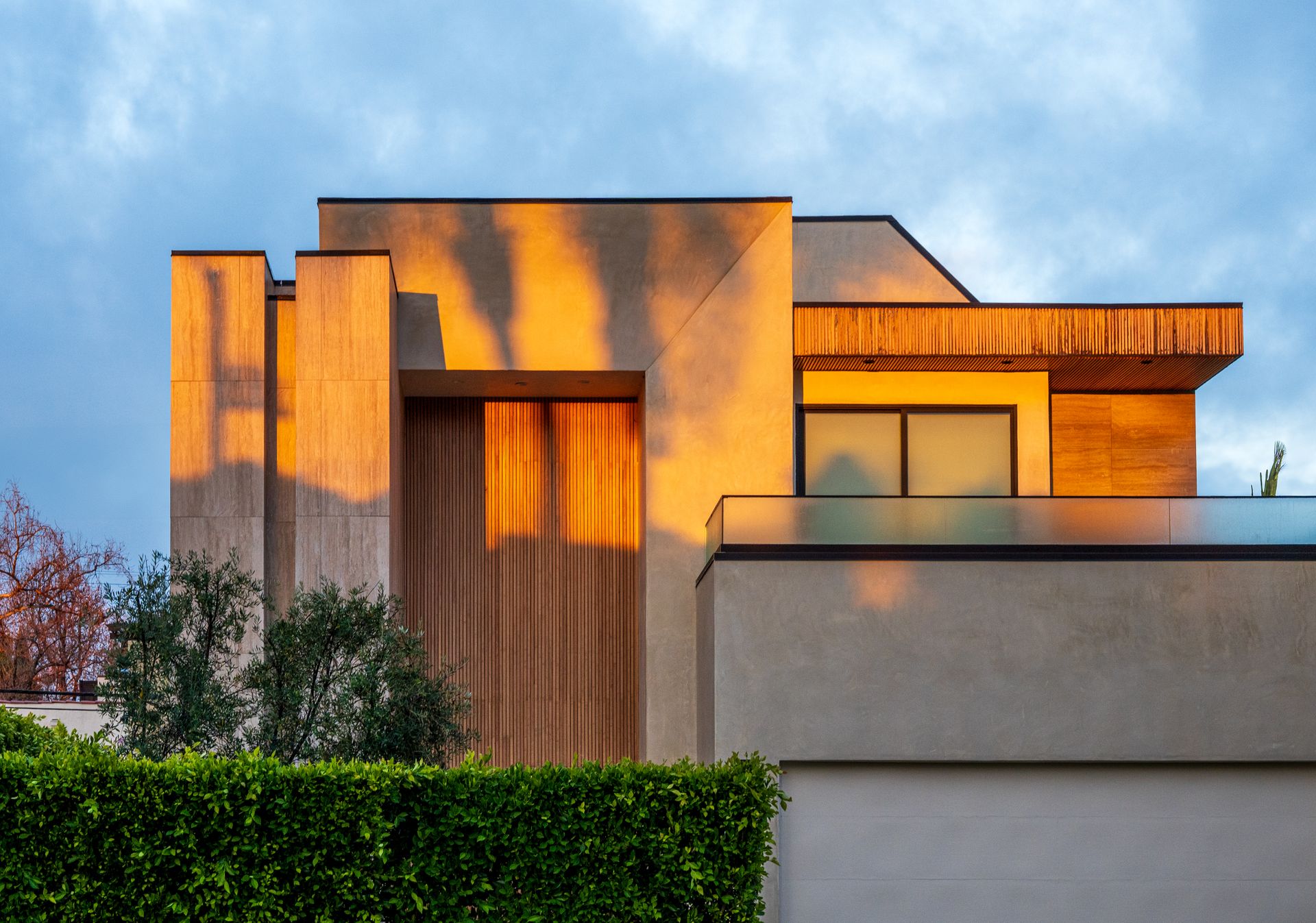 Wood-clad modern residence in warm evening light — representative residential architecture